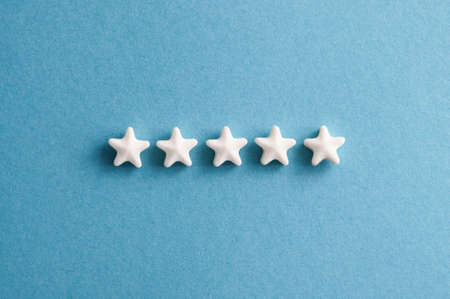 Five star rating feedback. Stars on blue backgroundの写真素材