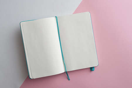 Minimalistic white and pink flat lay with blank notebook