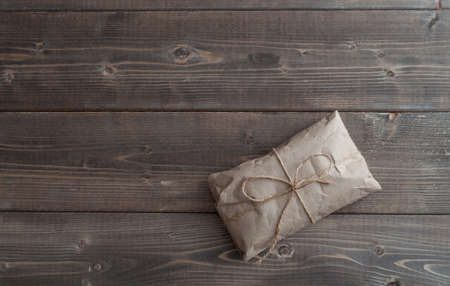 Postal package wrapped in craft paper on white background. Gift. Template. Mockup. Layoutの写真素材