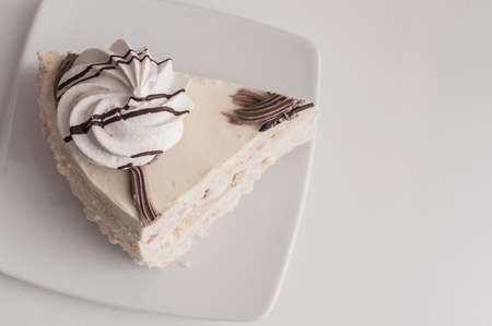 White cake with merinques and cream on the tableの写真素材