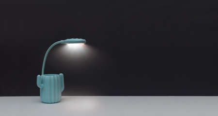 Workplace in muted tones in minimal style with white table and mint colored lampの写真素材