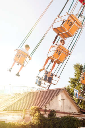 Kids having fun on summer school break. Funfair. Amusement park. Nostalgic. Summer vacationの写真素材