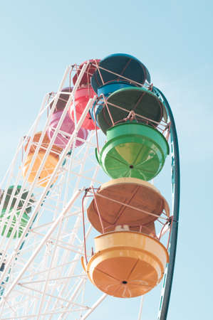 Big ferries wheel at the amusement park with multicolored cabinesの写真素材