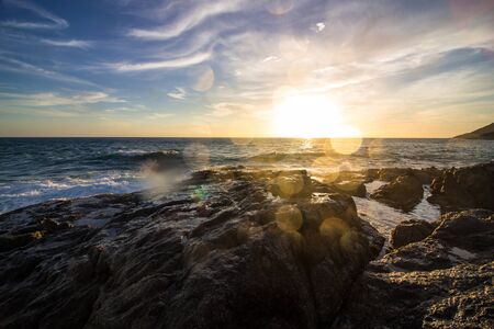 Splashes of waves on the rocky seashoreの写真素材