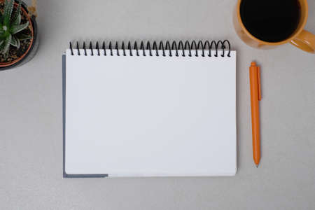 School notebook with pen and coffee on the table
