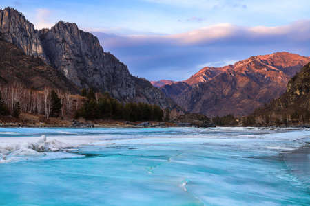 Scenic frozen river and mountains landscapeの写真素材