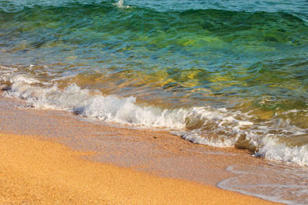 Beautiful sea on sandy coast closeupの写真素材