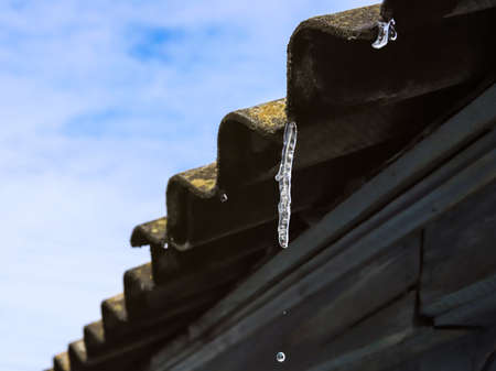Small icicle on old slate roof, sunnyの写真素材