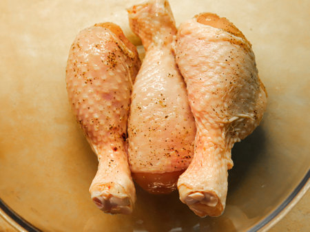 Marinated chicken drumsticks on table closeupの写真素材