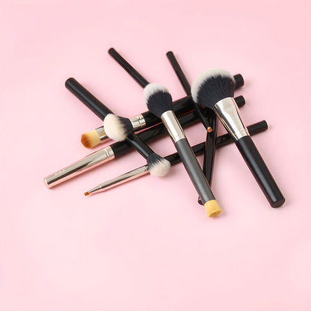 Set of makeup brushes on pink background. Flat lay, top view.の素材