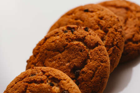 Fresh cookies with chocolate on a white background close-up.
