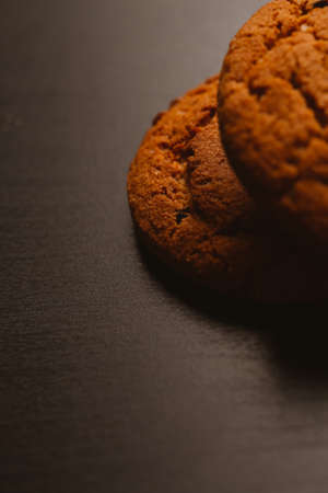 Fresh cookies with chocolate on a dark background.の写真素材