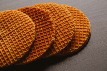 fresh waffles with caramel cookies on a black background.の写真素材