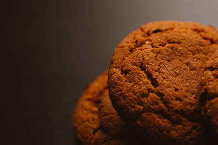 Fresh cookies with chocolate on a dark background.の写真素材