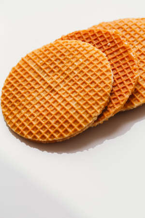 fresh waffles with caramel cookies on a white background close-up.の写真素材