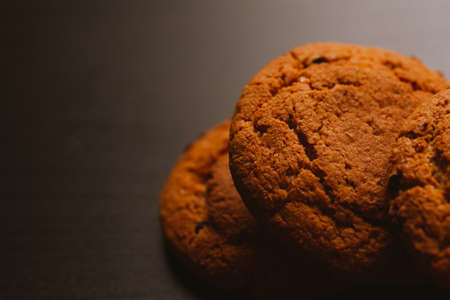 Fresh cookies with chocolate on a dark background.の写真素材
