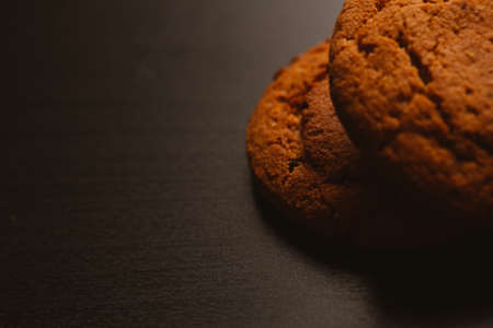 Fresh cookies with chocolate on a dark background.の写真素材