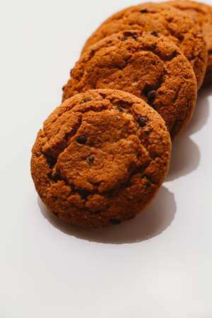 Fresh cookies with chocolate on a white background close-up.