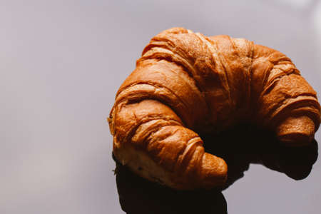 fresh croissant from the puff pastry on a black background.の写真素材