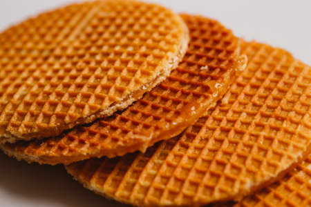 fresh waffles with caramel cookies on a white background close-up.の写真素材