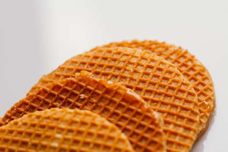 fresh waffles with caramel cookies on a white background close-up.の写真素材
