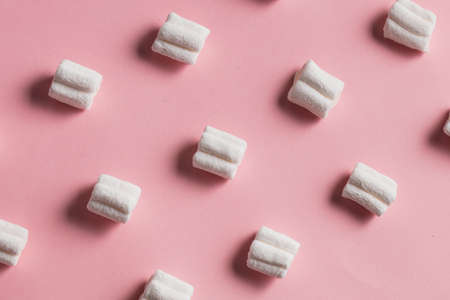 sweet white marshmallow, candy on pink background, top view flat lay.food, sweets, treat concepts