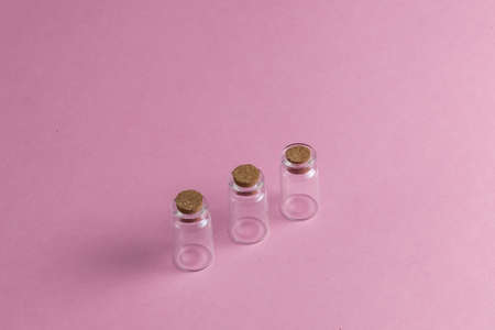 empty ampoules on the pink table. close up top view photo. copy space. three amps without powder