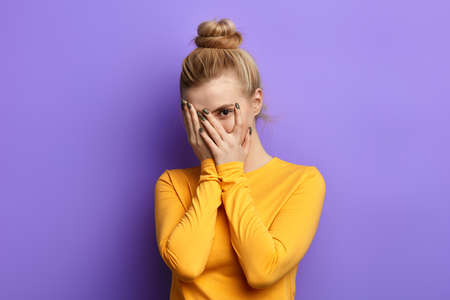 Stressed scared woman covering her face with palm, feeling afraid of stressful examination,beautiful...