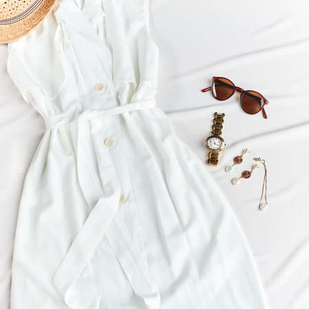 white summer outfit, watch, sunglasses, earrings braslet top view photoの写真素材