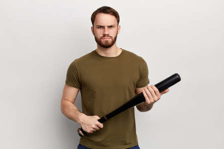 Angry nervous unhappy man with a bat bat isolated on white background. isolated white background....