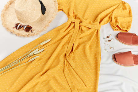 woman is looking forward to warm summer days. composition of summer outfit. top cropped view photoの写真素材