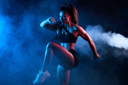 flexible athlete girl concentrated on training exercise, close up side view photo. isolated black...