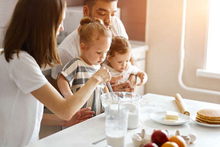 young parents and their kids learning the secrets of cooking. close up photo. hobby, interestの写真素材