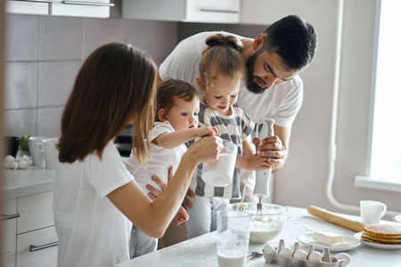 family with two children cooking acording grandmothers recipes. close up photoの写真素材