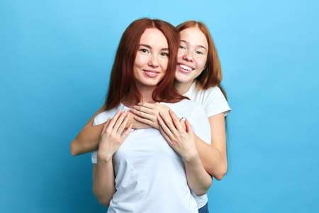 chraming two friends posing to the camera, close up portrait, beauty, people, youth, family relationの写真素材