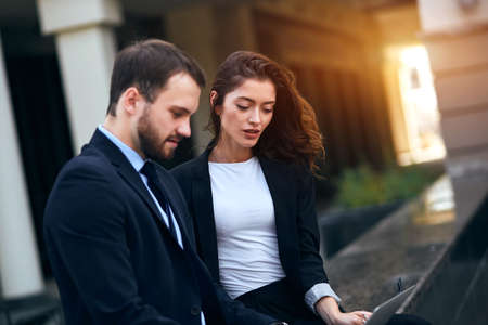 young motivated employees in fashion suits taking part online conference. close up side view photo