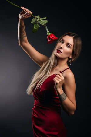 slim pleasant sexy singer with raised arm posing to the camera during the concert, performance. close up photo. pastime, leisureの写真素材