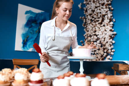 creative cook decorating dessert with pinecorns, close up photo.girl taking parts in cooking contest