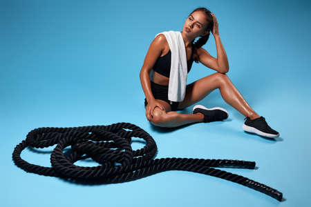 serious awesome fit girl scratching her head while having a rest after training.full length photo....