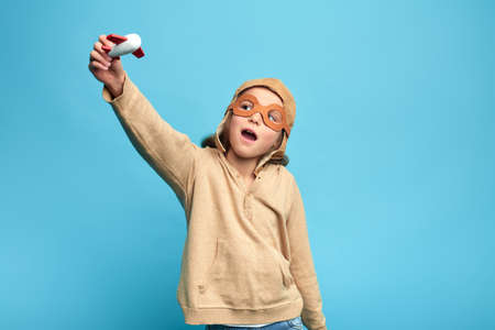 lovely girl is enjoying playing with a plane, hobby, interest concept. close up portrait, isolated...
