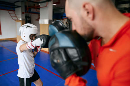 young talented boxer attacking his father. close up photoの写真素材