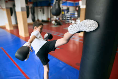 young boy exercising at gym , preparing for competition, close up back view photo.の写真素材