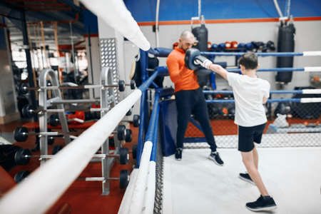 child and young man fighting , blurred foreground, full length photo
