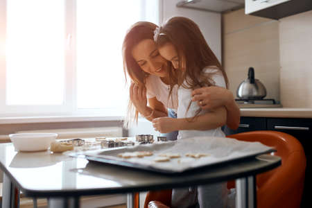 young smiling woman rejoicing at her childs success, close up side view photo. copy spaceの写真素材