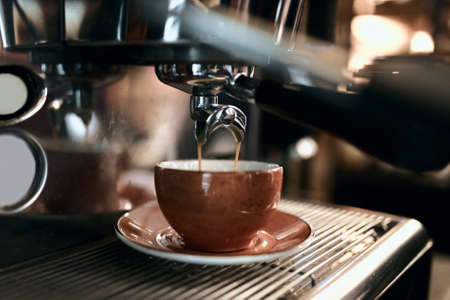 preparation method. Modern coffee machine.man using professional equipment for work, close up side...