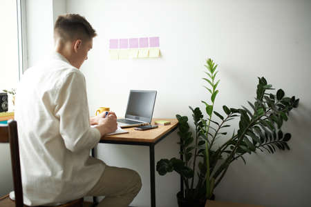 young man in white shirt learning to sell goods, new foreign language, guy consulting clients...