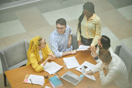 brainstorming process in a small start up company, top view photo.