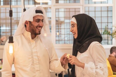 Muslim hijab woman share bitcoin with arabian businessman. Cryptocurrency concept.のeditorial素材