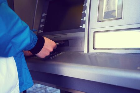 the girl raises money from the ATM - Imageの写真素材