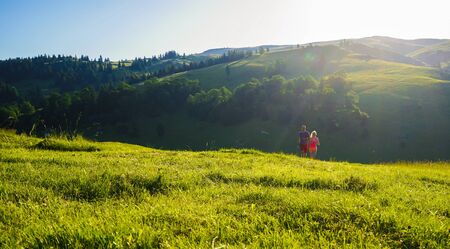Running fitness couple of runners doing sport on road outdoor. Active living man and woman jogging training cardio in summer outdoors nature.の写真素材